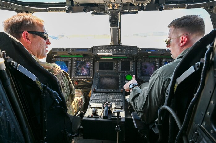 Two pilots sitting in the front of an aircraft