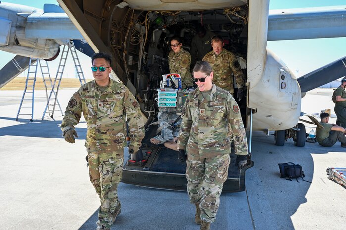 Four Airmen exiting an aircraft
