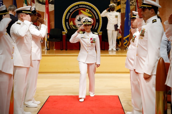 SILVER SPRING, Md. (Aug. 13, 2025) Capt. Franca Jones, departs through ceremonial sideboys during Naval Medical Research Command's (NMRC) Change of Command ceremony. The ceremony, presided over by Rear Adm. Guido Valdes, saw Jones relieved as commander by Capt. Eric Welsh. Valdes recently served as commander, Naval Medical Forces Pacific. NMRC, headquarters of Navy Medicine Research & Development, is engaged in a broad spectrum of activity from basic science in the laboratory to field studies in austere and remote areas of the world to investigations in operational environments. In support of Navy, Marine Corps and joint U.S. warfighter health, readiness and lethality, researchers study infectious diseases, biological warfare detection and defense, combat casualty care, environmental health concerns, aerospace and undersea medicine, operational mission support and epidemiology. (U.S. Navy Photo by Tommy Lamkin/ released)