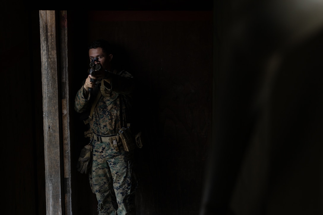 A U.S. Marine with 2nd Battalion, 23rd Marines, forward deployed with 4th Marine Regiment, 3d Marine Division as part of the Unit Deployment Program, secures a stairway and awaits reinforcements during military operations in urban terrain training during the Korean Marine Exercise Program 25.2 in Pocheon, South Korea, July 25, 2025. KMEP is conducted regularly between the ROK and U.S. Marine Corps to increase their combined capabilities through realistic training geared towards deterring threatsdeterrence and maintaining peace in the Indo-Pacific. (U.S. Marine Corps photo by Lance Cpl. Van Hoang)