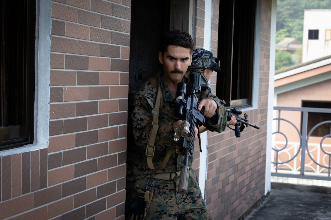 U.S. Navy Petty Officer Third Class Grant Jasinski, a corpsman with 2nd Battalion, 23rd Marines, forward deployed with 4th Marine Regiment, 3d Marine Division as part of the Unit Deployment Program, and Republic of Korea Marines conduct room clearing tactics during military operations in urban terrain training during the Korean Marine Exercise Program 25.2 in Pocheon, South Korea, July 25, 2025. KMEP is conducted regularly between the ROK and U.S. Marine Corps to increase their combined capabilities through realistic training geared towards deterring threatsdeterrence and maintaining peace in the Indo-Pacific. (U.S. Marine Corps photo by Lance Cpl. Van Hoang)