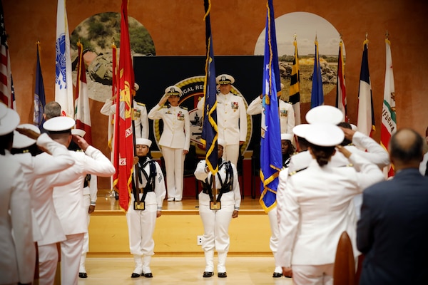 SILVER SPRING, Md. (Aug. 13, 2025) Sailors with the Walter Reed National Military Medical Center Color Guard parade the colors during Naval Medical Research Command's (NMRC) Change of Command ceremony. The ceremony, presided over by Rear Adm. Valdes, saw Capt. Franca Jones relieved as commander by Capt. Eric Welsh. Valdes recently served as commander, Naval Medical Forces Pacific. NMRC, headquarters of Navy Medicine Research & Development, is engaged in a broad spectrum of activity from basic science in the laboratory to field studies in austere and remote areas of the world to investigations in operational environments. In support of Navy, Marine Corps and joint U.S. warfighter health, readiness and lethality, researchers study infectious diseases, biological warfare detection and defense, combat casualty care, environmental health concerns, aerospace and undersea medicine, operational mission support and epidemiology. (U.S. Navy Photo by Tommy Lamkin/ released)