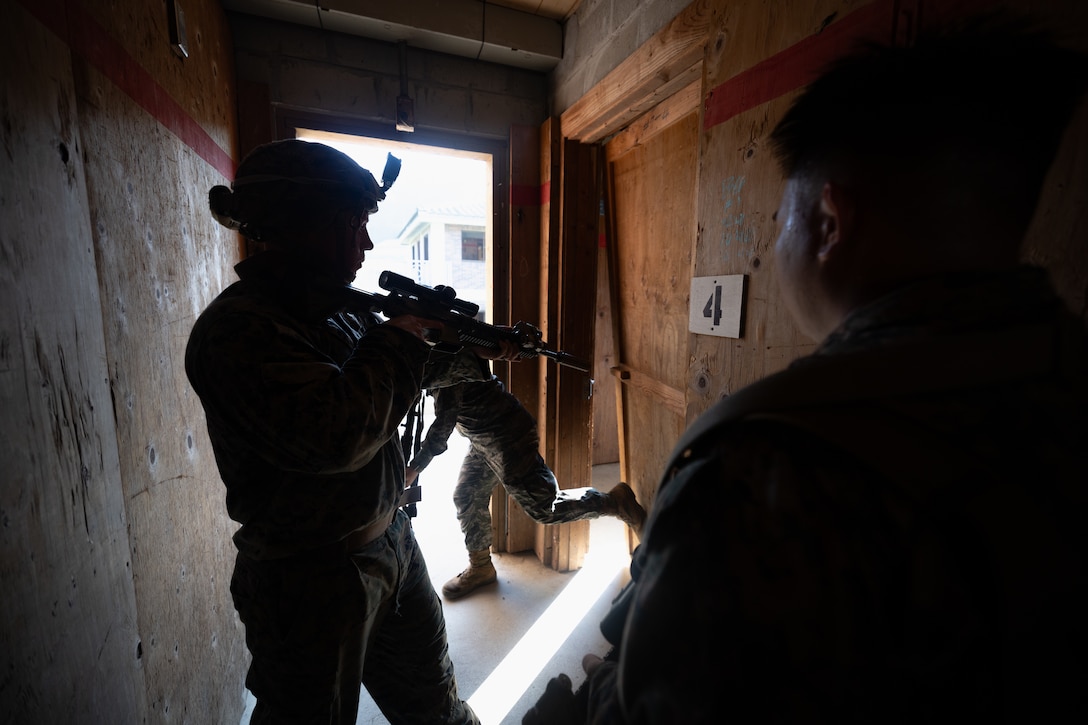 U.S. Marines and Sailors with 2nd Battalion, 23rd Marines, forward deployed with 4th Marine Regiment, 3d Marine Division as part of the Unit Deployment Program, and a Republic of Korea Marine breach a room during bilateral military operations in urban terrain training during the Korean Marine Exercise Program 25.2 in Pocheon, South Korea, July 25, 2025. KMEP is conducted regularly between the ROK and U.S. Marine Corps to increase their combined capabilities through realistic training geared towards deterrence and maintaining peace in the Indo-Pacific. (U.S. Marine Corps photo by Lance Cpl. Van Hoang)