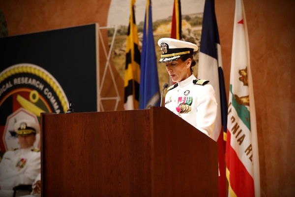 SILVER SPRING, Md. (Aug. 13, 2025) Capt. Franca Jones, commander Naval Medical Research Command (NMRC) delivers remarks during NMRC'S Change of Command ceremony. The ceremony, presided over by Rear Adm. Guido Valdes, saw Jones relieved as commander by Capt. Eric Welsh. Valdes recently served as commander, Naval Medical Forces Pacific. NMRC, headquarters of Navy Medicine Research & Development, is engaged in a broad spectrum of activity from basic science in the laboratory to field studies in austere and remote areas of the world to investigations in operational environments. In support of Navy, Marine Corps and joint U.S. warfighter health, readiness and lethality, researchers study infectious diseases, biological warfare detection and defense, combat casualty care, environmental health concerns, aerospace and undersea medicine, operational mission support and epidemiology. (U.S. Navy Photo by Tommy Lamkin/ released)
