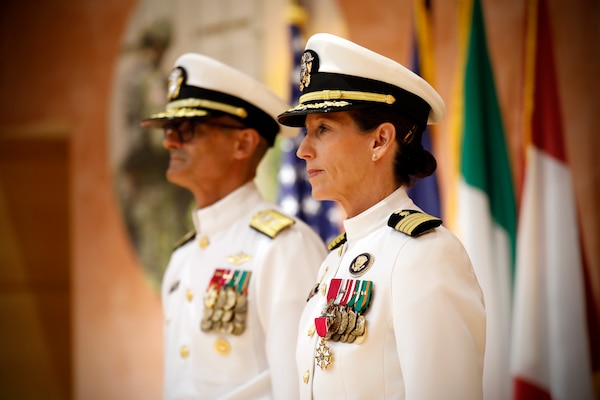 SILVER SPRING, Md. (Aug. 13, 2025) Rear Adm. Guido Valdes and Capt. Franca Jones, commander Naval Medical Research Command (NMRC) stand on-stage during NMRC'S Change of Command ceremony. The ceremony, presided over by Valdes, saw Jones relieved as commander by Capt. Eric Welsh. Valdes recently served as commander, Naval Medical Forces Pacific. NMRC, headquarters of Navy Medicine Research & Development, is engaged in a broad spectrum of activity from basic science in the laboratory to field studies in austere and remote areas of the world to investigations in operational environments. In support of Navy, Marine Corps and joint U.S. warfighter health, readiness and lethality, researchers study infectious diseases, biological warfare detection and defense, combat casualty care, environmental health concerns, aerospace and undersea medicine, operational mission support and epidemiology. (U.S. Navy Photo by Tommy Lamkin/ released)