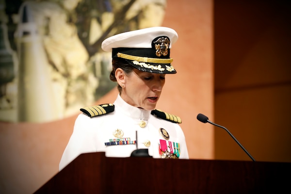 SILVER SPRING, Md. (Aug. 13, 2025) Capt. Franca Jones, commander, Naval Medical Research Command (NMRC), reads her orders during NMRC's Change of Command ceremony. The ceremony, presided over by Rear Adm. Guido Valdes, saw Jones relieved as commander by Capt. Eric Welsh. Valdes recently served as commander, Naval Medical Forces Pacific. NMRC, headquarters of Navy Medicine Research & Development, is engaged in a broad spectrum of activity from basic science in the laboratory to field studies in austere and remote areas of the world to investigations in operational environments. In support of Navy, Marine Corps and joint U.S. warfighter health, readiness and lethality, researchers study infectious diseases, biological warfare detection and defense, combat casualty care, environmental health concerns, aerospace and undersea medicine, operational mission support and epidemiology. (U.S. Navy Photo by Tommy Lamkin/ released)