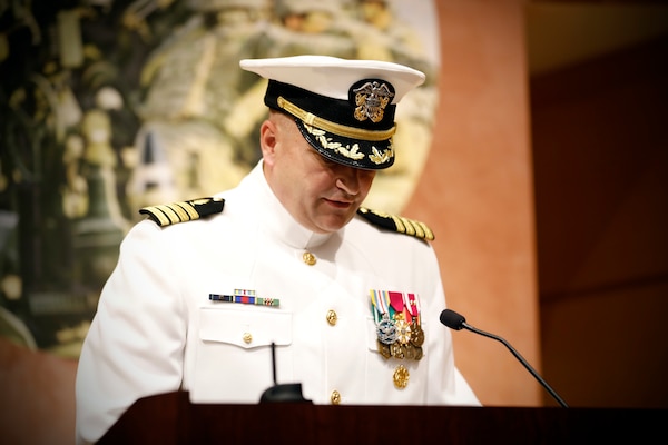 SILVER SPRING, Md. (Aug. 13, 2025) Capt. Eric Welsh reads his orders during Naval Medical Research Command's (NMRC) Change of Command ceremony. The ceremony, presided over by Rear Adm. Guido Valdes, saw Capt. Franca Jones relieved as commander by Welsh. Valdes recently served as commander, Naval Medical Forces Pacific. NMRC, headquarters of Navy Medicine Research & Development, is engaged in a broad spectrum of activity from basic science in the laboratory to field studies in austere and remote areas of the world to investigations in operational environments. In support of Navy, Marine Corps and joint U.S. warfighter health, readiness and lethality, researchers study infectious diseases, biological warfare detection and defense, combat casualty care, environmental health concerns, aerospace and undersea medicine, operational mission support and epidemiology. (U.S. Navy Photo by Tommy Lamkin/ released)