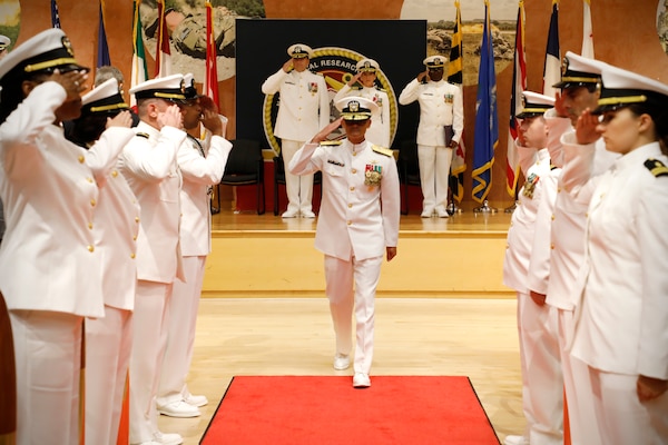 SILVER SPRING, Md. (Aug. 13, 2025) Rear Adm. Guido Valdes departs through ceremonial sideboys during NMRC's Change of Command ceremony. The ceremony, presided over by Valdes, saw Capt. Franca Jones relieved as commander by Capt. Eric Welsh. Valdes recently served as commander, Naval Medical Forces Pacific. NMRC, headquarters of Navy Medicine Research & Development, is engaged in a broad spectrum of activity from basic science in the laboratory to field studies in austere and remote areas of the world to investigations in operational environments. In support of Navy, Marine Corps and joint U.S. warfighter health, readiness and lethality, researchers study infectious diseases, biological warfare detection and defense, combat casualty care, environmental health concerns, aerospace and undersea medicine, operational mission support and epidemiology. (U.S. Navy Photo by Tommy Lamkin/ released)