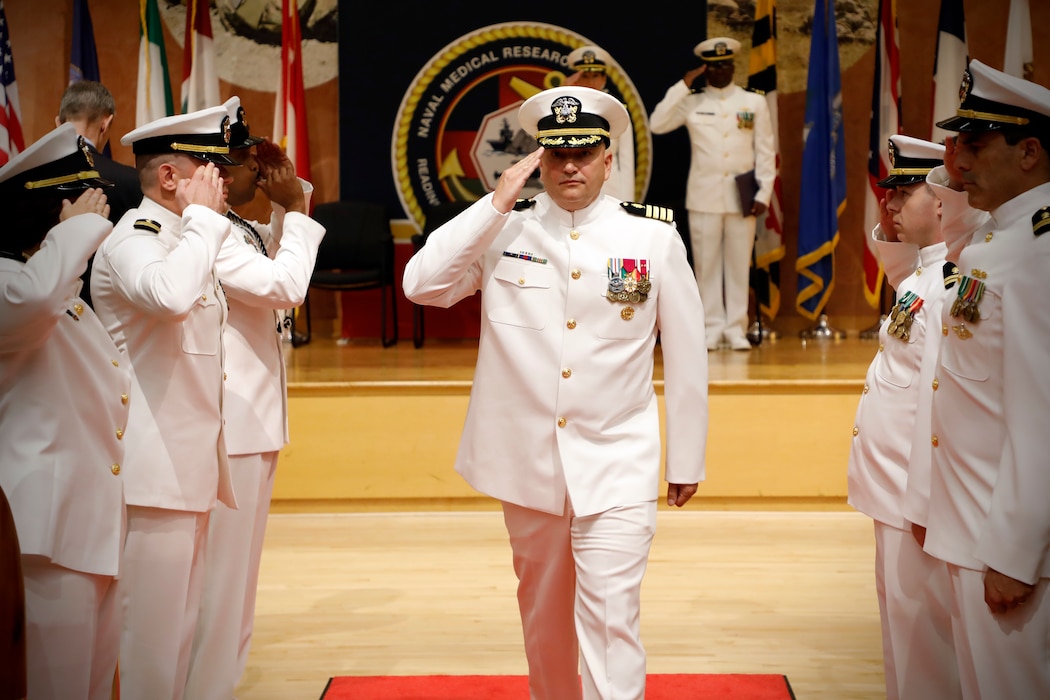 SILVER SPRING, Md. (Aug. 13, 2025) Capt. Eric Welsh, commander, Naval Medical Research Command (NMRC) departs through ceremonial sideboys during NMRC's Change of Command ceremony. The ceremony, presided over by Rear Adm. Guido Valdes, saw Capt. Franca Jones relieved as commander by Welsh. Valdes recently served as commander, Naval Medical Forces Pacific. NMRC, headquarters of Navy Medicine Research & Development, is engaged in a broad spectrum of activity from basic science in the laboratory to field studies in austere and remote areas of the world to investigations in operational environments. In support of Navy, Marine Corps and joint U.S. warfighter health, readiness and lethality, researchers study infectious diseases, biological warfare detection and defense, combat casualty care, environmental health concerns, aerospace and undersea medicine, operational mission support and epidemiology. (U.S. Navy Photo by Tommy Lamkin/ released)