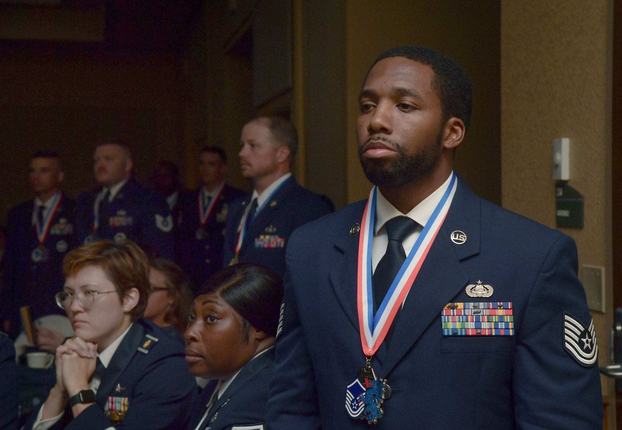 People in military uniform stand at attention