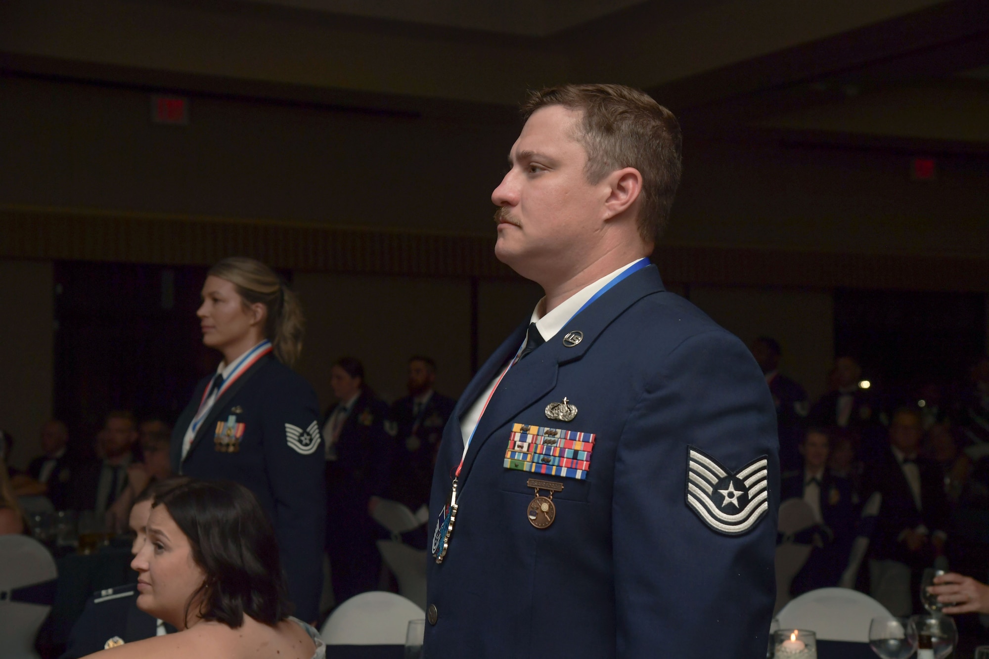 People in military uniform stands at attention