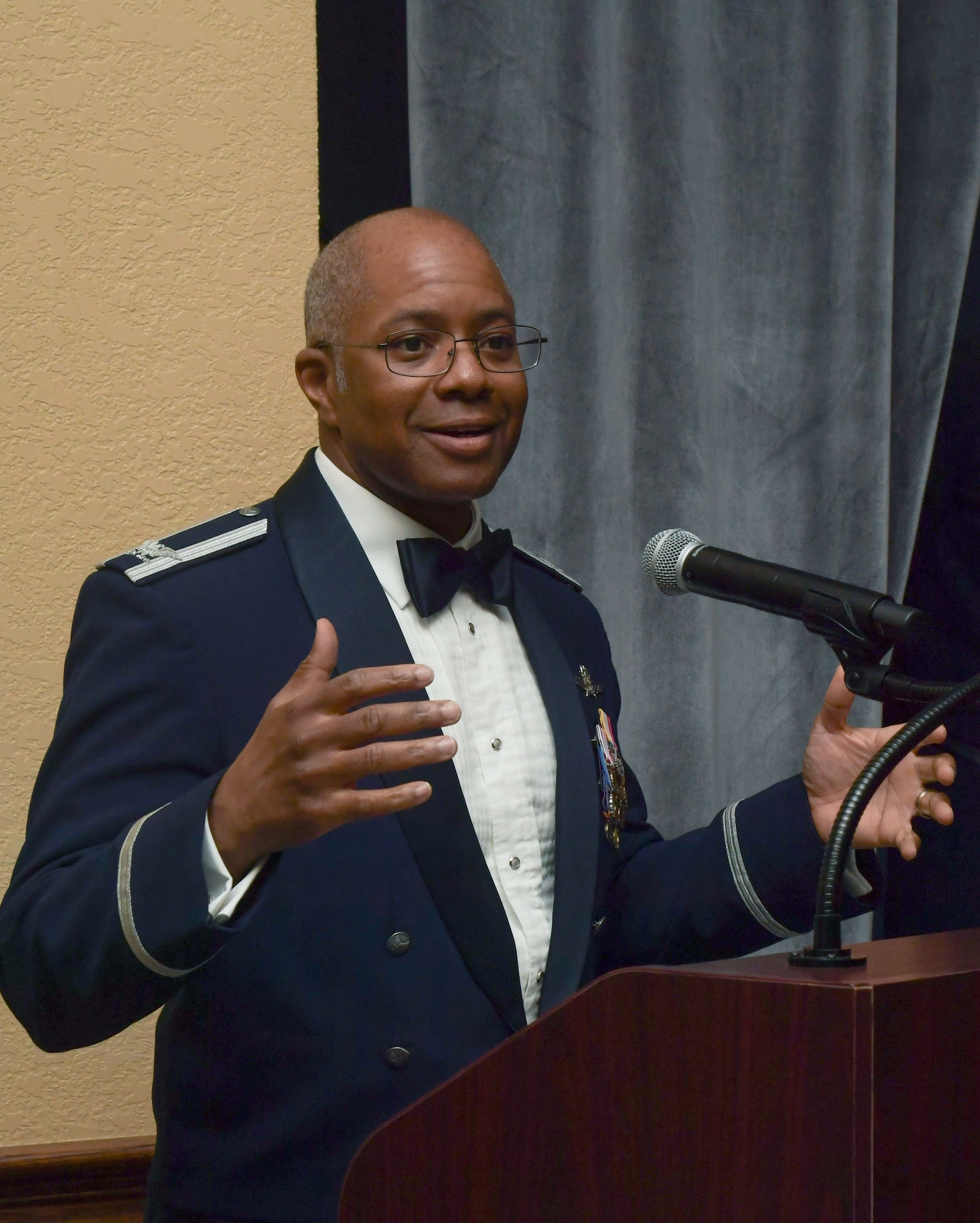 A man in military uniform speaks into a microphone