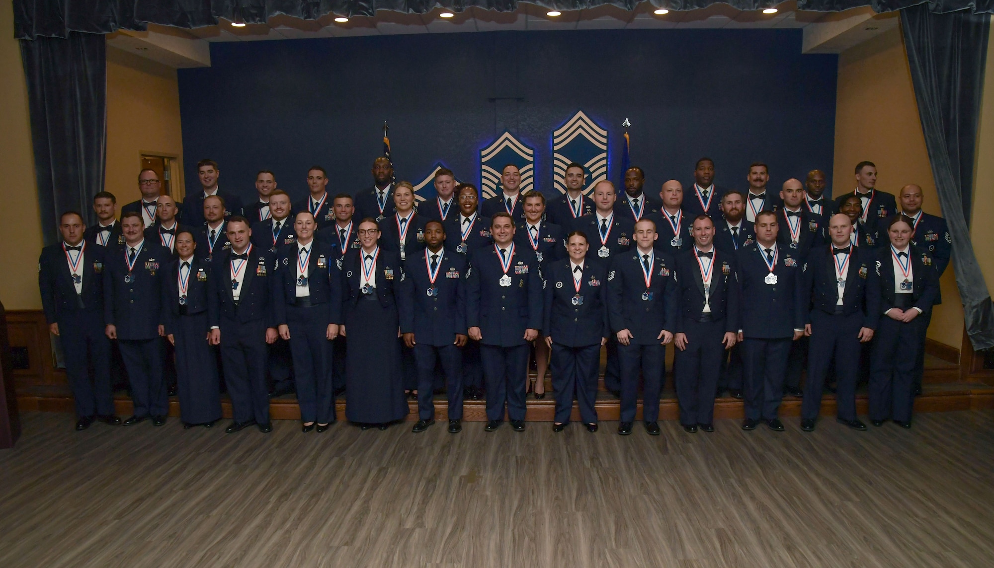 People in military uniform pose for a group photo
