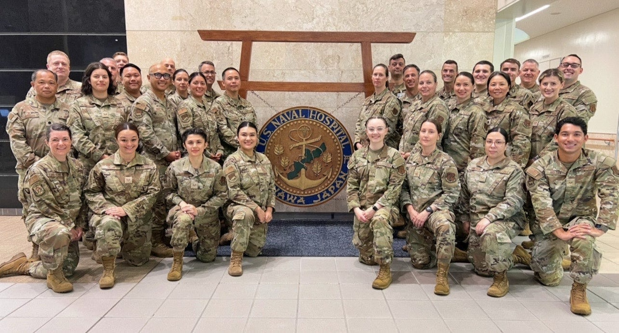 Airmen from the 142nd Medical Group pose for a group photo at the U.S. Naval Hospital in Okinawa, Japan, July 17, 2025, following the completion of Medical Facility Annual Training (MFAT). The team provided direct clinical support across 16 departments during the two-week mission, enhancing joint operational readiness and strengthening partnerships with Navy and Marine medical personnel. (Courtesy photo)