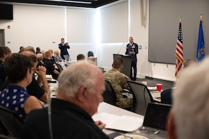 Col Secrest talking to a room full of people
