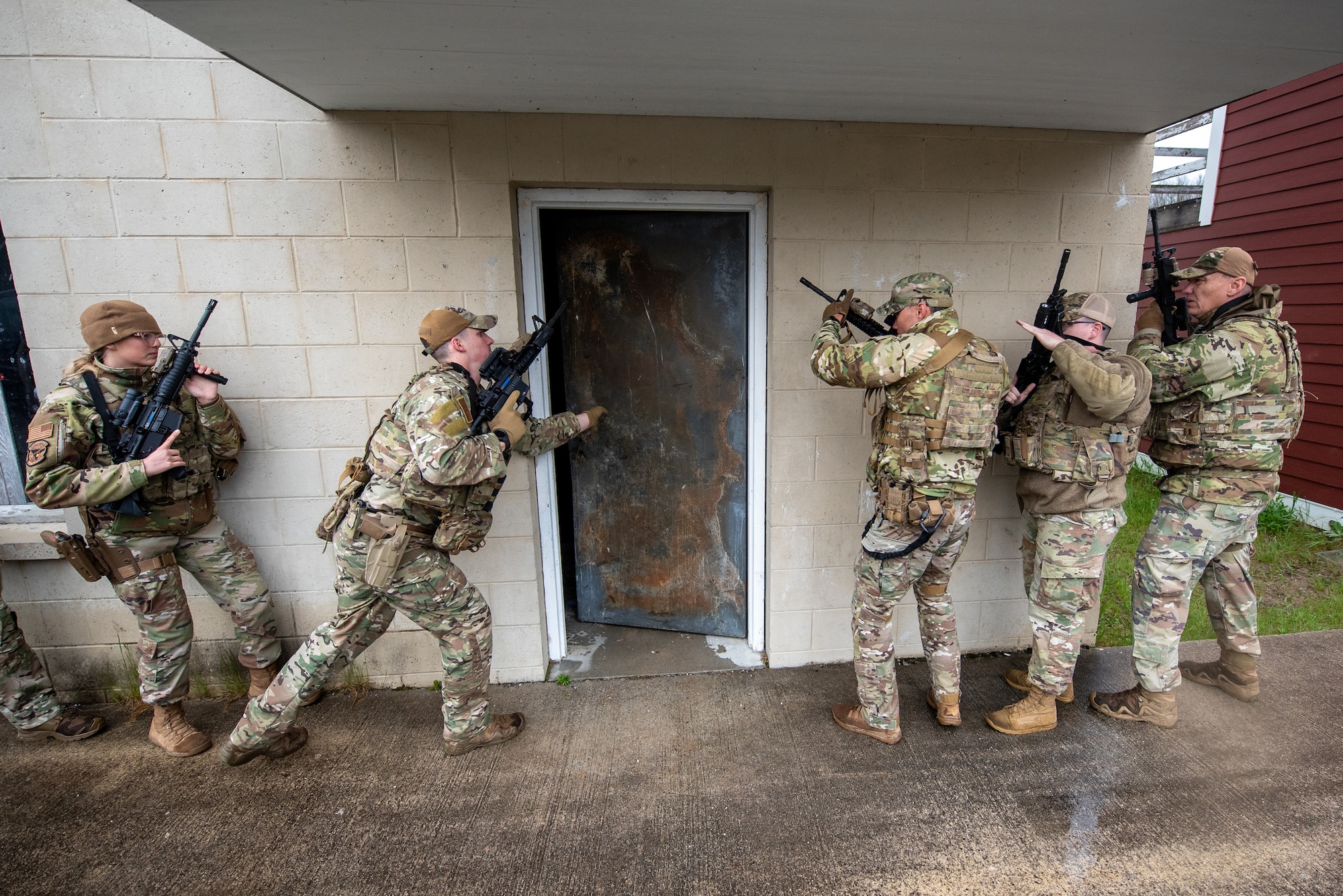 Airmen from the Kentucky Air National Guard’s 123rd Security Forces Squadron and 123rd Contingency Response Group prepare to make entry to a building during a close-quarters battle exercise at the Alpena Combat Readiness Training Center in Alpena, Mich., May 23, 2025. More than 50 Airmen from the Kentucky Air Guard, along with members of the Colorado Air National Guard’s 233rd  Security Forces Squadron and the Ecuadorian Air Force, participated in a nine-day field exercise here May 21 to 29. (U.S. Air National Guard photo by Phil Speck)