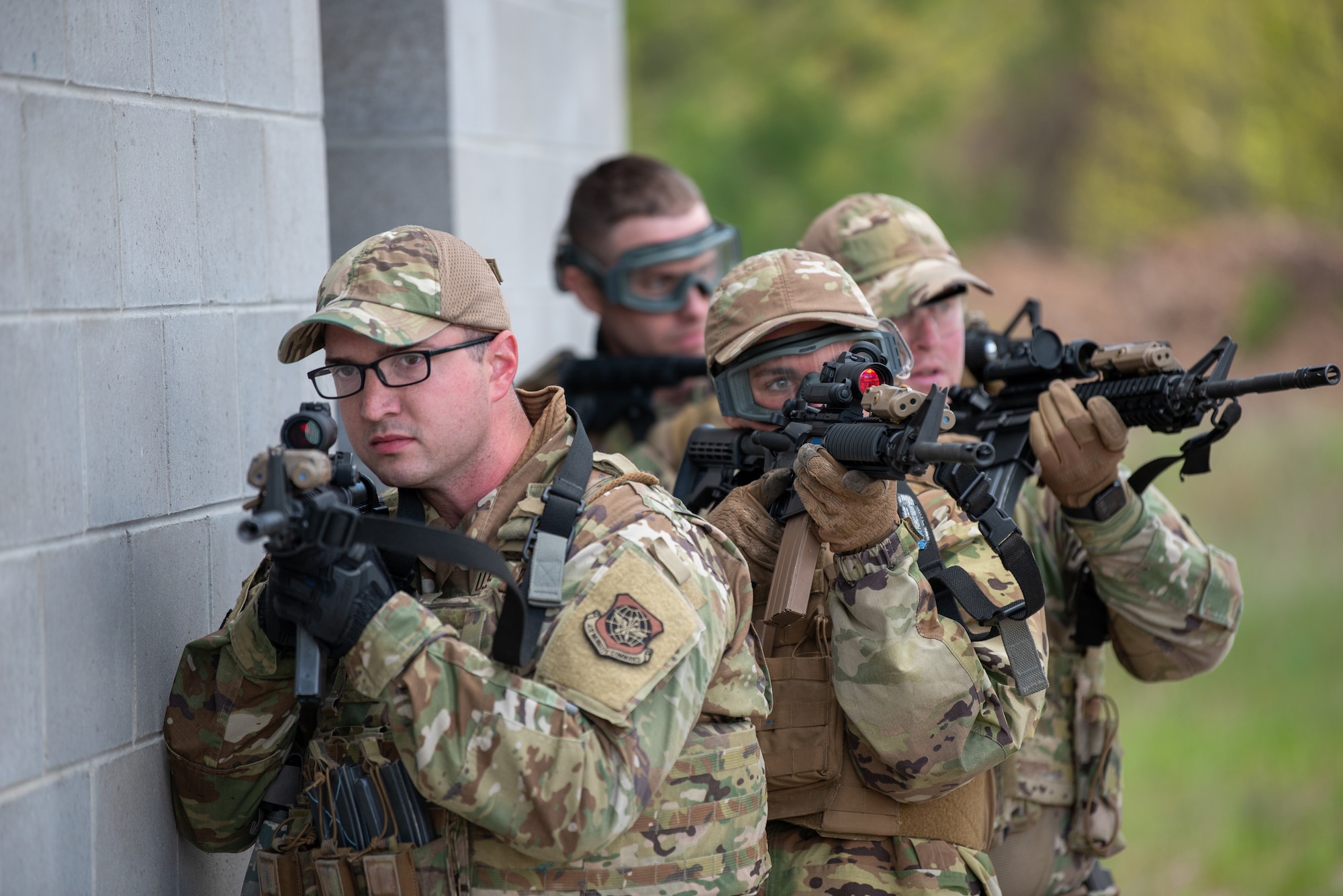 Airmen from the Kentucky Air National Guard’s 123rd Security Forces Squadron and 123rd Contingency Response Group prepare to make entry to a building during a close-quarters battle exercise at the Alpena Combat Readiness Training Center in Alpena, Mich., May 24, 2025. More than 50 Airmen from the Kentucky Air Guard, along with members of the Colorado Air National Guard’s 233rd  Security Forces Squadron and the Ecuadorian Air Force, participated in a nine-day field exercise here May 21 to 29. (U.S. Air National Guard photo by Phil Speck)