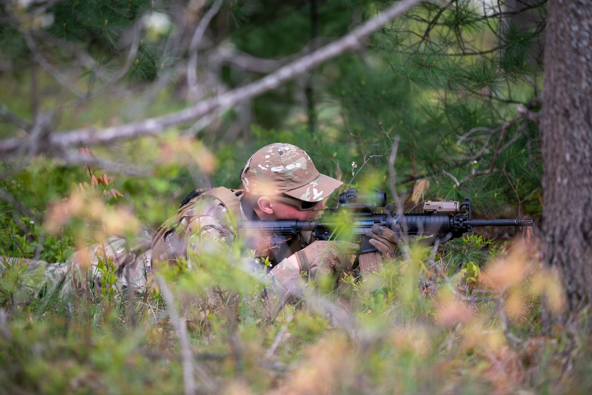 An Airman from the Kentucky Air National Guard’s 123rd Contingency Response Group lays prone to fortify a defensive position at the Alpena Combat Readiness Training Center in Alpena, Mich., May 24, 2025. More than 50 Airmen from the Kentucky Air Guard, along with members of the Colorado Air National Guard’s 233rd  Security Forces Squadron and the Ecuadorian Air Force, participated in a nine-day field exercise here May 21 to 29. (U.S. Air National Guard photo by Phil Speck)
