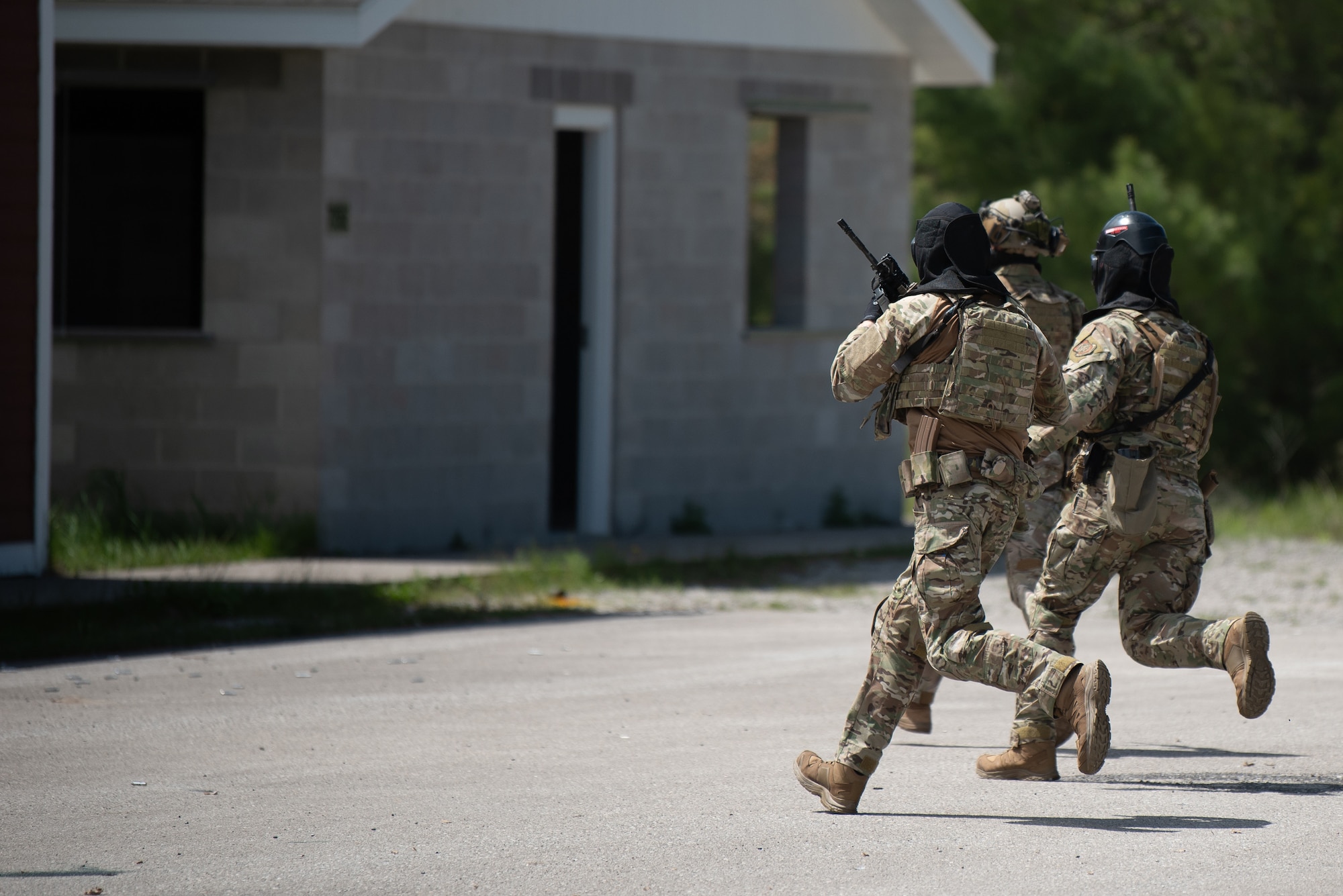Airmen from the Kentucky Air National Guard’s 123rd Security Forces Squadron and 123rd Contingency Response Group move to cover during an exercise at the Alpena Combat Readiness Training Center in Alpena, Mich., May 26, 2025. More than 50 Airmen from the 123rd SFS and 123rd CRG, along with members of the Colorado Air National Guard’s 233rd  Security Forces Squadron and the Ecuadorian Air Force, participated in a nine-day field exercise here May 21 to 29. (U.S. Air National Guard photo by Phil Speck)