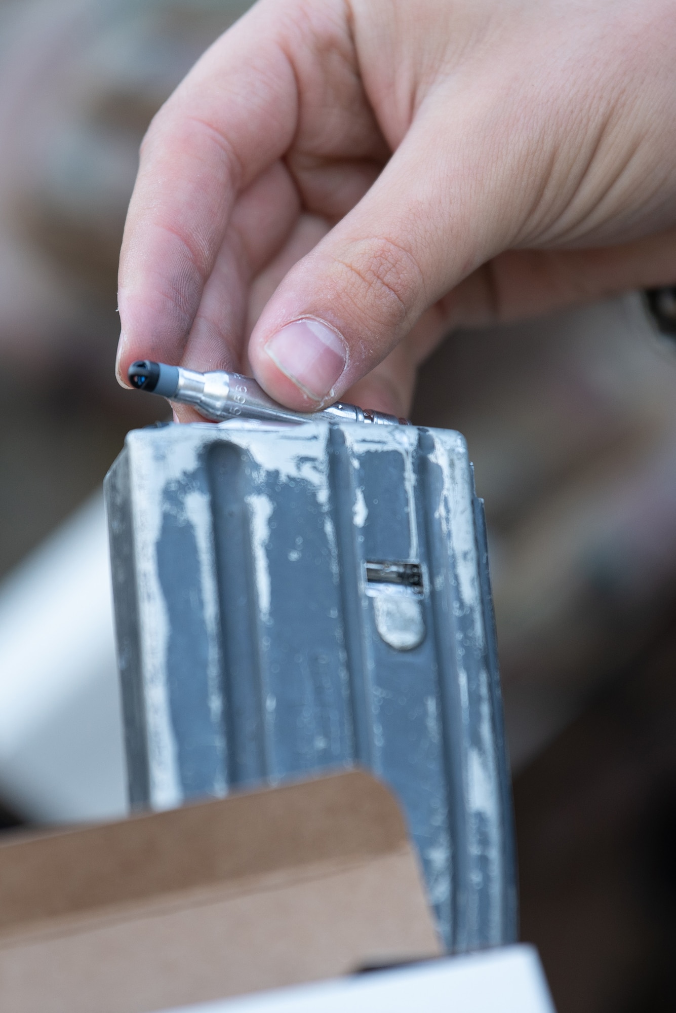 Simulated ammunition is loaded into a magazine for a security forces exercise at the Alpena Combat Readiness Training Center in Alpena, Mich., May 23, 2025. More than 50 Airmen from the Kentucky Air National Guard’s 123rd Security Forces Squadron and 123rd Contingency Response Group, along with members of the Colorado Air National Guard’s 233rd  Security Forces Squadron and the Ecuadorian Air Force, participated in a nine-day field exercise here May 21 to 29. (U.S. Air National Guard photo by Phil Speck)