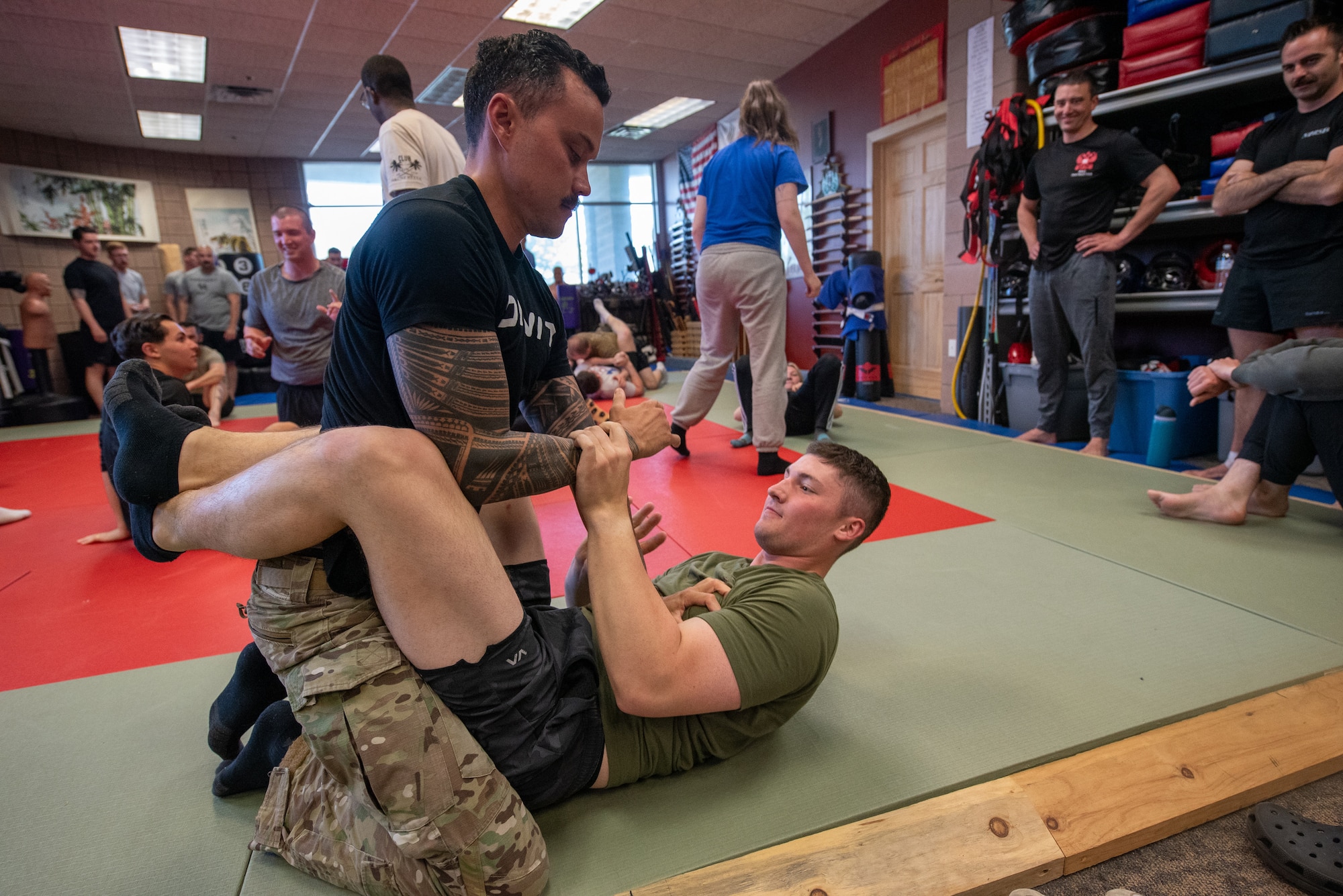 Tech. Sgt. Franklin Sloat, left, a security forces member with the Kentucky Air National Guard’s 123rd Contingency Response Group, grapples with Senior Airman Michael Mitchell, another CRG security forces member, during a field exercise at the Alpena Combat Readiness Training Center in Alpena, Mich., May 25, 2025. More than 50 Airmen from the Kentucky Air Guard, along with members of the Colorado Air National Guard’s 233rd  Security Forces Squadron and the Ecuadorian Air Force, participated in the nine-day exercise here May 21 to 29. (U.S. Air National Guard photo by Phil Speck)