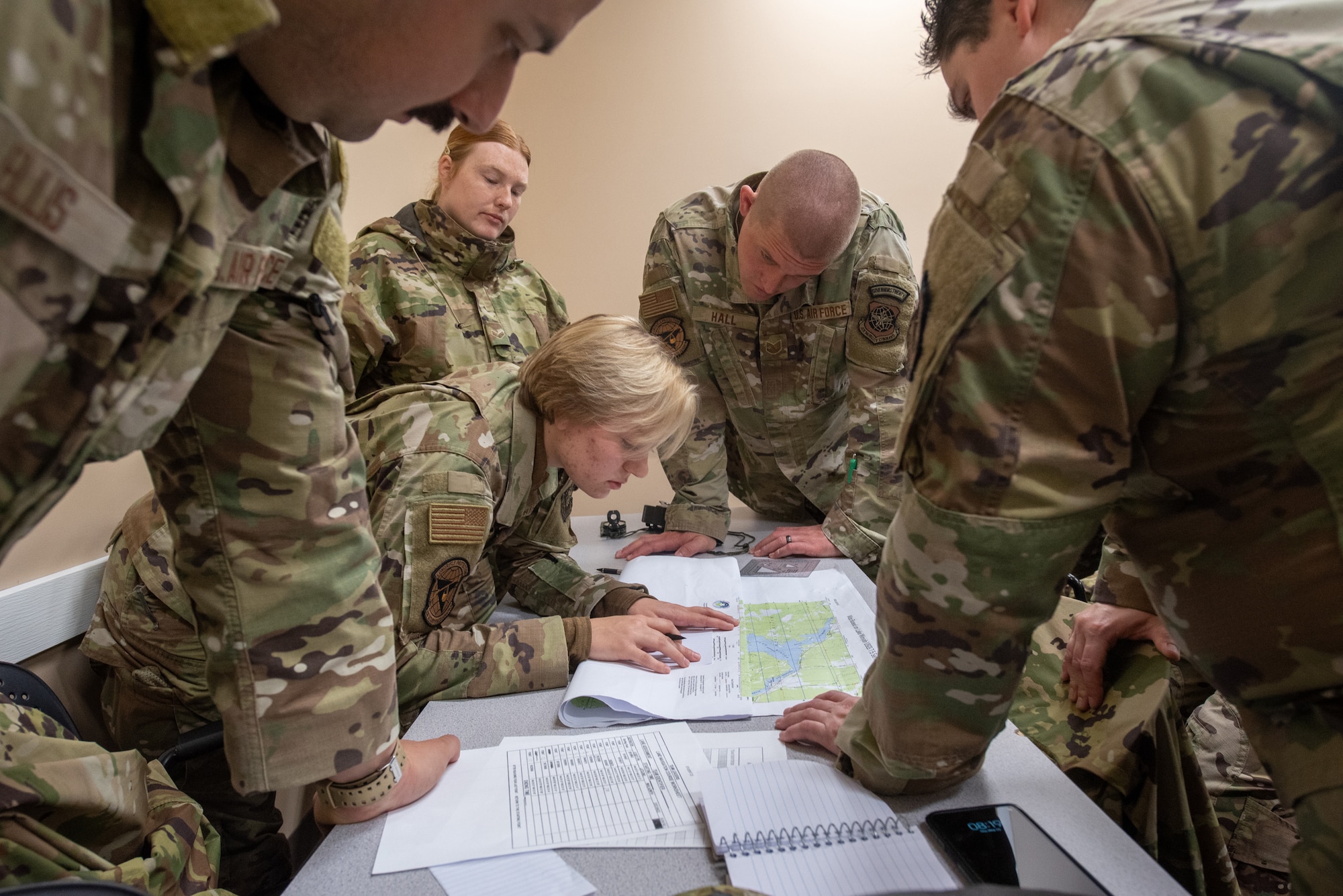 Airmen from the Kentucky Air National Guard’s 123rd Security Forces Squadron and 123rd Contingency Response Group plan routes prior to executing a land navigation course at the Alpena Combat Readiness Training Center in Alpena, Mich., May 22, 2025. More than 50 Airmen from the 123rd SFS and 123rd CRG, along with members of the Colorado Air National Guard’s 233rd  Security Forces Squadron and the Ecuadorian Air Force, participated in a nine-day field exercise here May 21 to 29. (U.S. Air National Guard photo by Phil Speck)