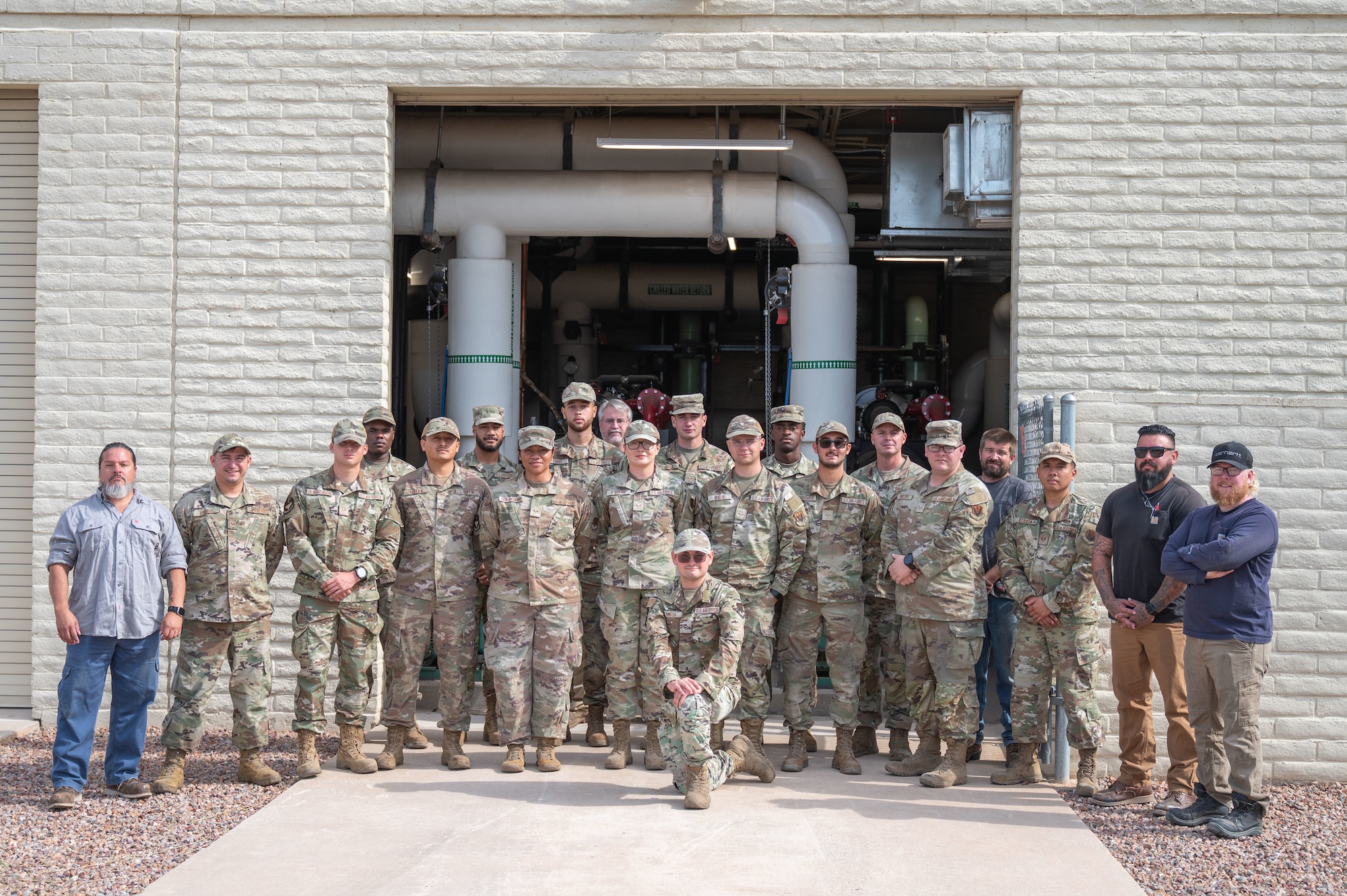 The 355th Civil Engineering Squadron Heating, Ventilation and Air Conditioning shop poses for a group photo at Davis-Monthan Air Force Base, Arizona, August 13, 2025. The HVAC team stood in front of a facility known as “The Beast” which powers over a quarter of the air conditioning throughout Davis-Monthan’s facilities. (U.S. Air Force photo by Airman Jaden Kidd)