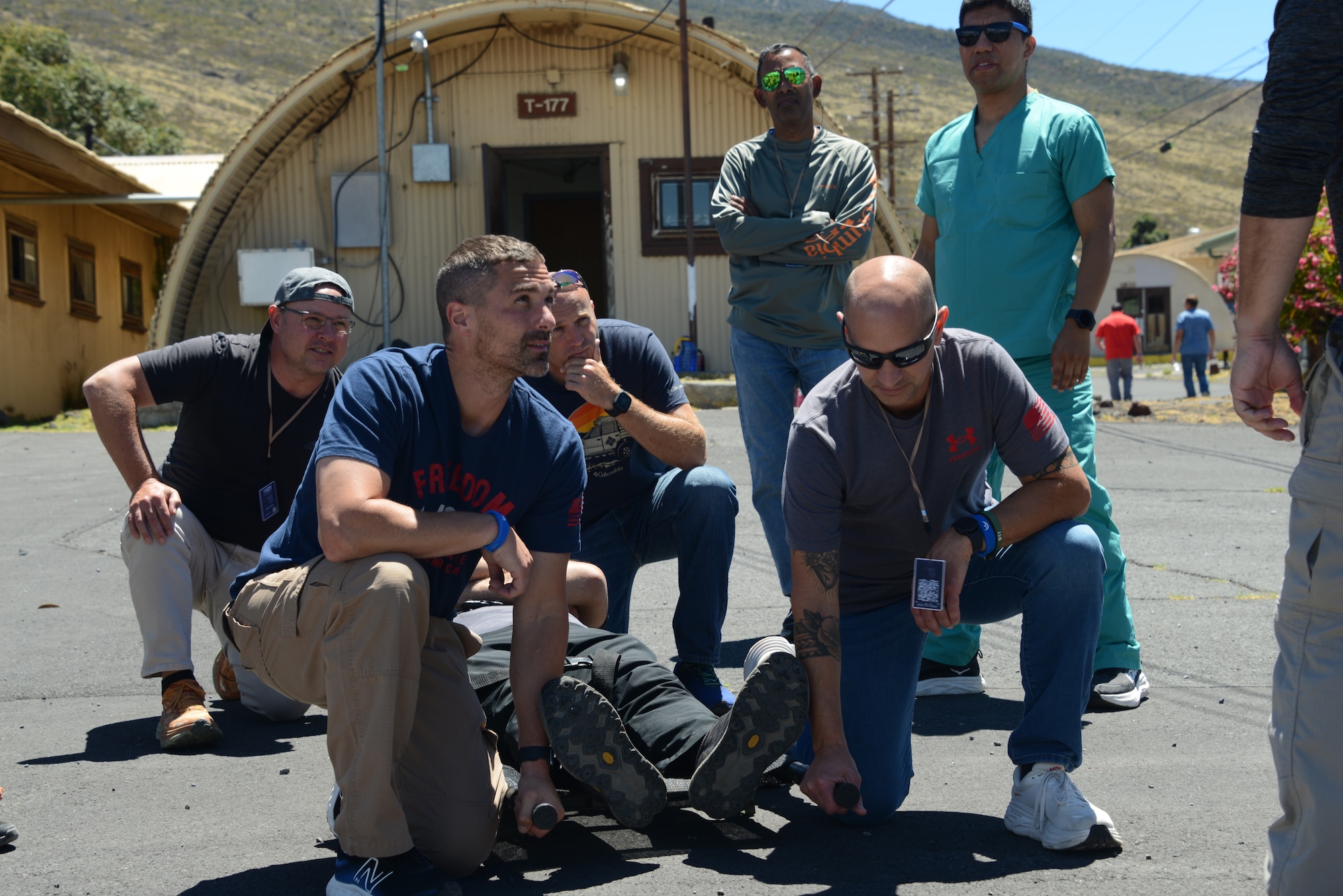 U.S. National Guard members prepare to lift an occupied litter