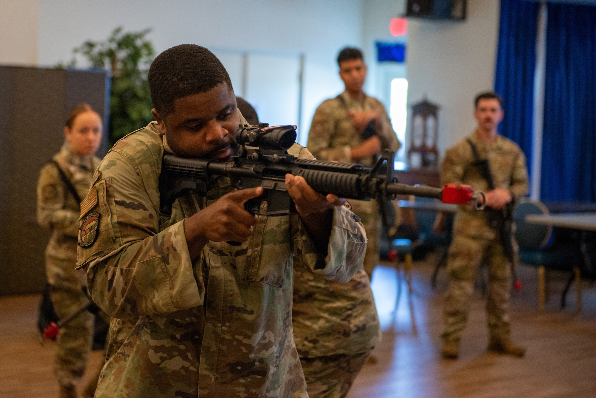 An Airman aims a rifle.