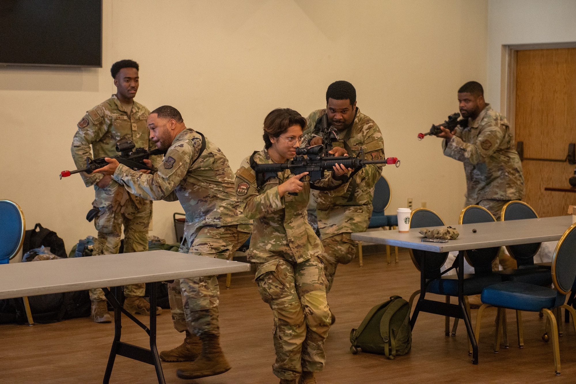 Airmen enter a simulated room to clear it of hostile forces.