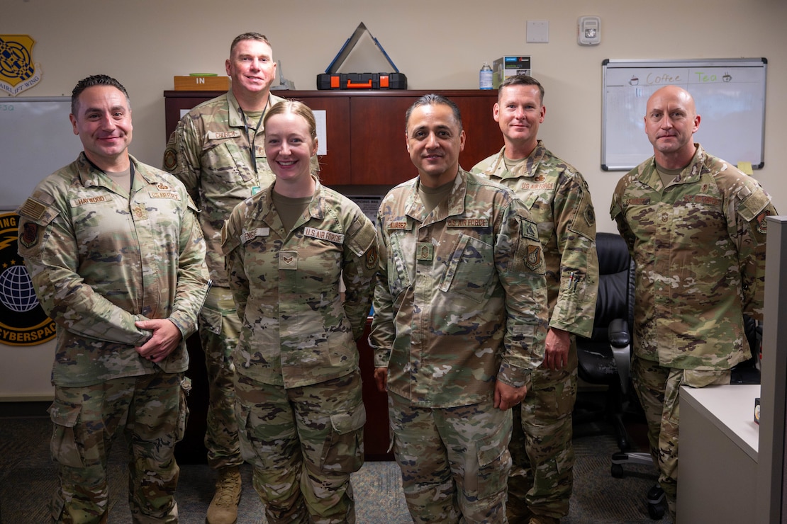 U.S. Air Force senior enlisted leaders pose for a photo after coining an Airman on Joint Base Pearl Harbor-Hickam, Hawaii.
