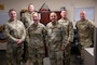 U.S. Air Force senior enlisted leaders pose for a photo after coining an Airman on Joint Base Pearl Harbor-Hickam, Hawaii.