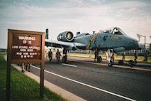 An A-10 Thunderbolt II aircraft gets towed down the road to be put on display at a traffic circle on Camp Humphreys, South Korea, August 2, 2025.