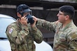 U.S. Army Sgt. Remi Torres, assigned to Headquarters and Headquarters Company, U.S. Army Garrison Yongsan-Casey, helps Korean Augmentation to the U.S. Army Pfc. Hyun Jae Chung don his promask before a gas chamber drill at North Star Range, Uijeongbu, South Korea, March 5, 2025.