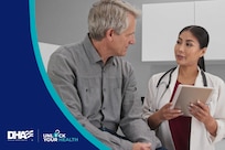 Man in grey shirt speaks to a doctor