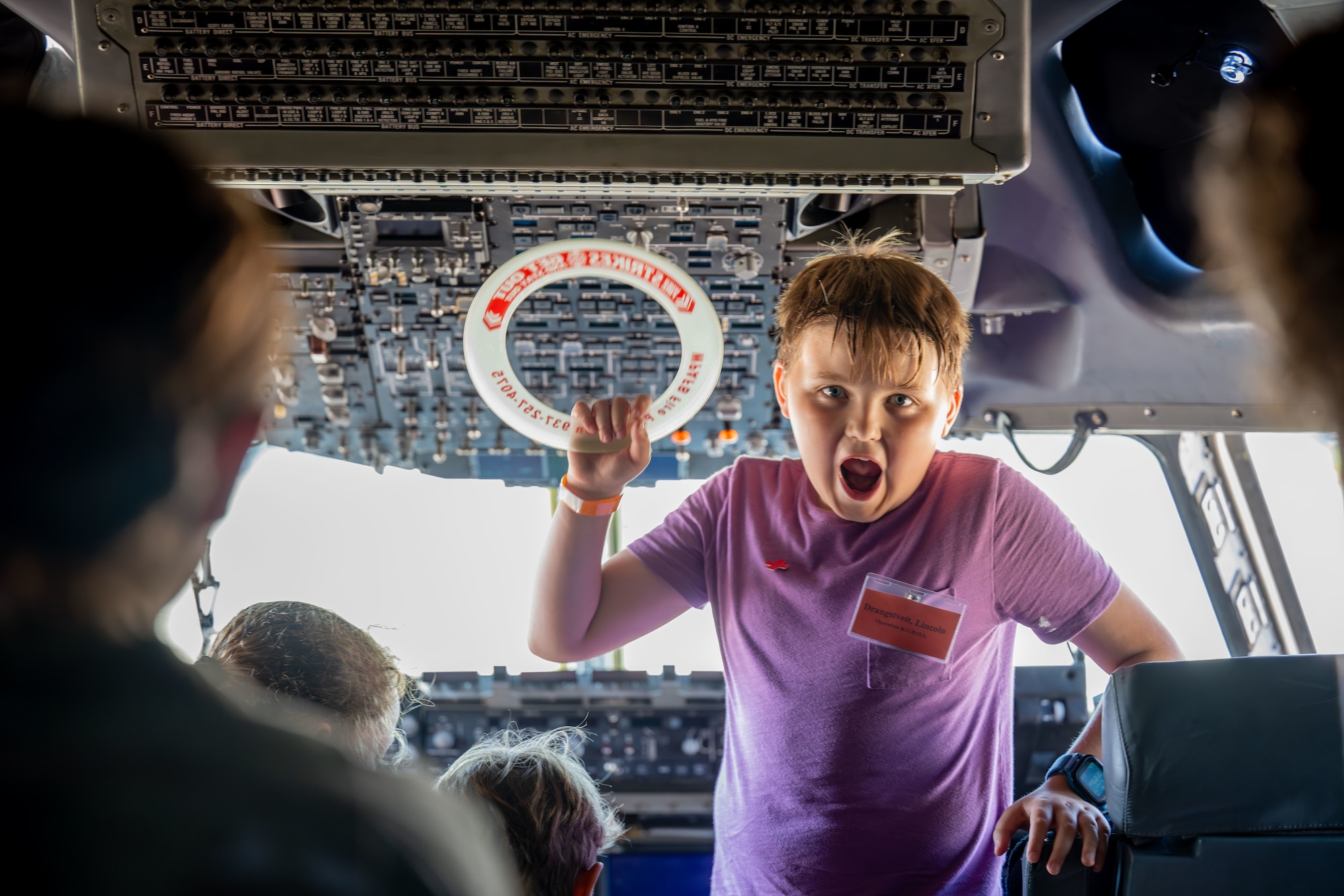 Military children tour the cockpit of a C-17 Globemaster from the 445th Air Lift Wing during the Kids Understanding Deployment Operations (KUDOS) event Aug. 8, 2025, at Wright-Patterson Air Force Base, Ohio. KUDOS teaches children about deployments through age-appropriate activities (U.S. Air Force photo by Jack Gardner)