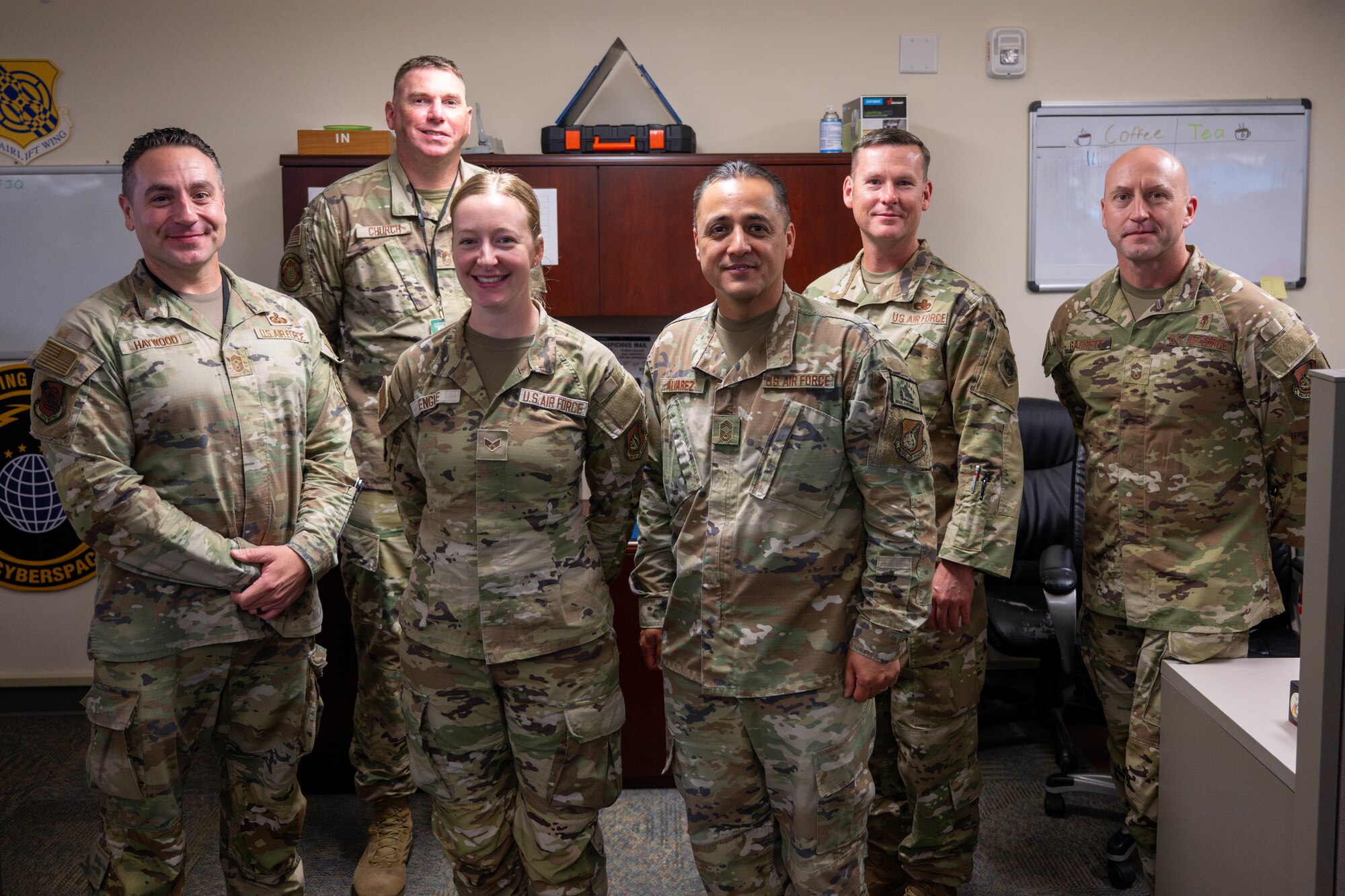 U.S. Air Force senior enlisted leaders pose for a photo after coining an Airman on Joint Base Pearl Harbor-Hickam, Hawaii.