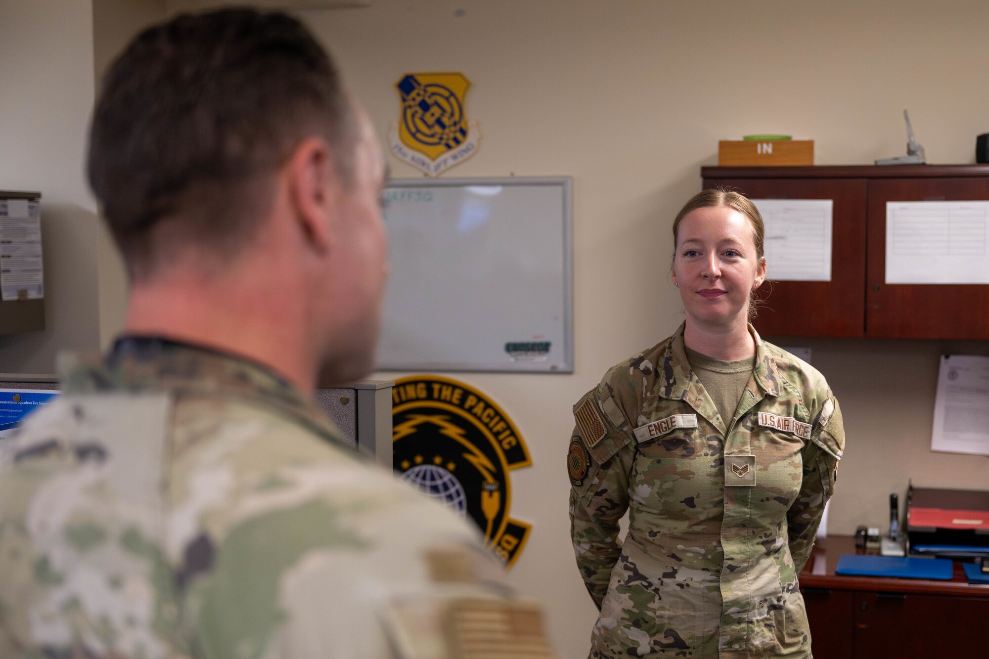 A U.S. Air Force Airmen receives praise from the Wing's command chief on Joint Base Pearl Harbor-Hickam, Hawaii.