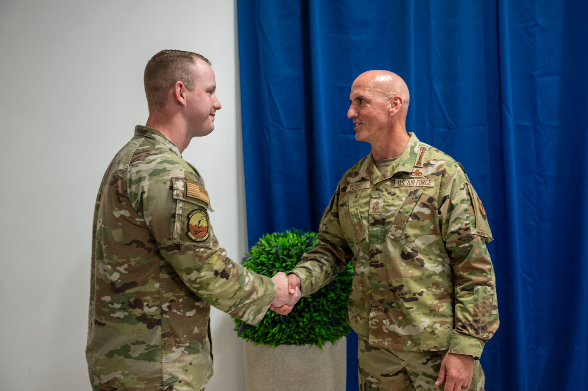 Chief Flosi right of frame shakes the hand of SSgt Josh Bell on the left hand side of frame