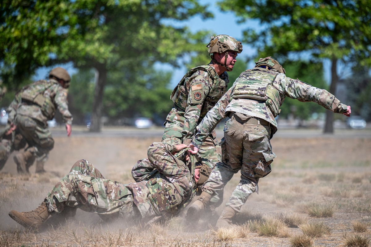Members of the 22nd Combat Air Base Squadron perform drag and carry drills during Advanced Ready Training at Fairchild Air Force Base, Wash., July 24, 2025. The course mimics the Expeditionary Center’s version of ART, teaching Airmen to increase their mission resilience and discipline in a deployed environment. (U.S. Air Force photo by Staff Sgt. Ryan Gomez)