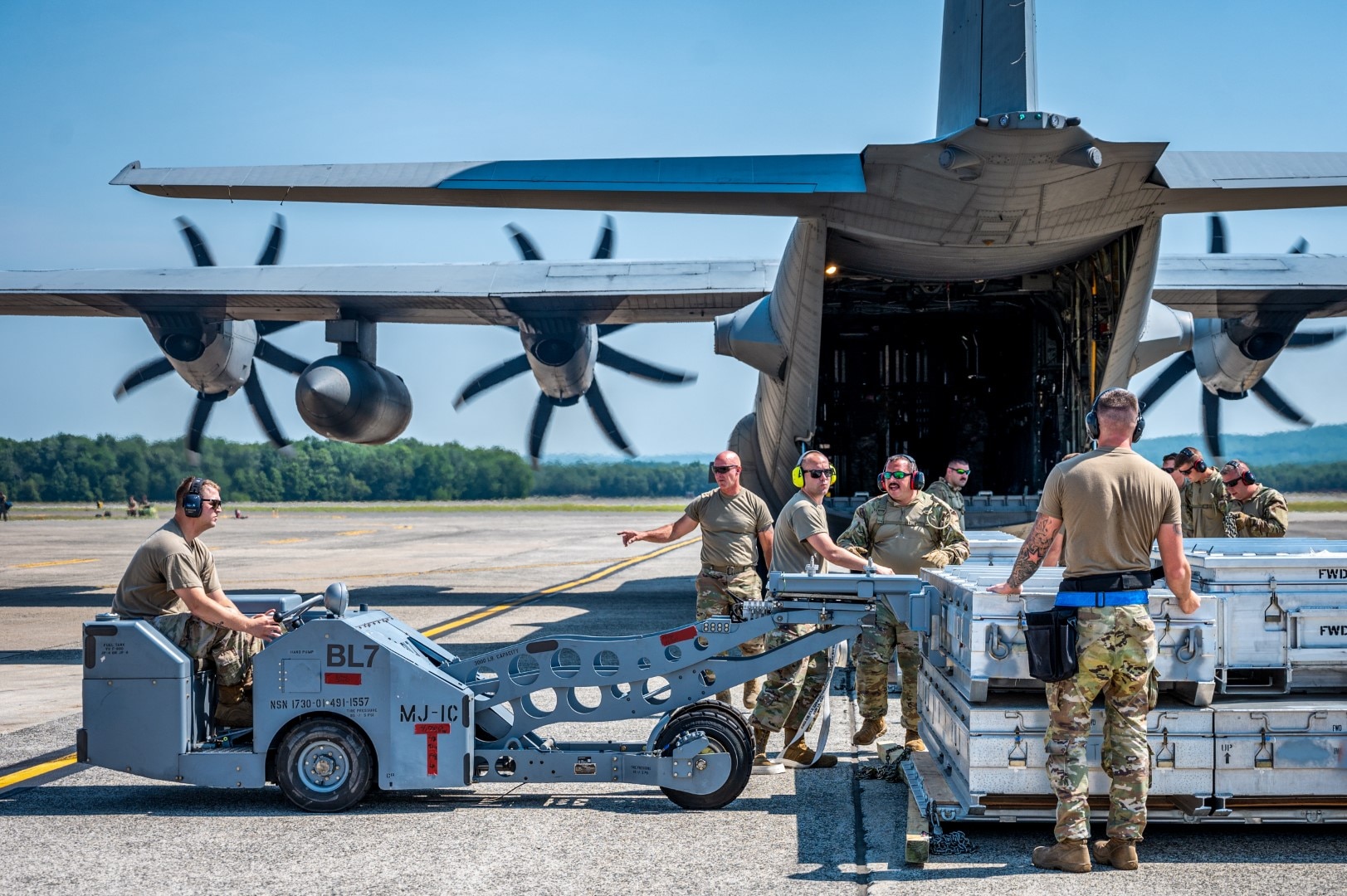 Crews from the 103d Airlift Wing and 104th Fighter Wing unload missile cases during a Distributed Integrated Combat Turn exercise at Westover Air Reserve Base, Massachusetts, July 24, 2025.