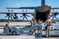 Crews from the 103d Airlift Wing and 104th Fighter Wing unload missile cases during a Distributed Integrated Combat Turn exercise at Westover Air Reserve Base, Massachusetts, July 24, 2025.