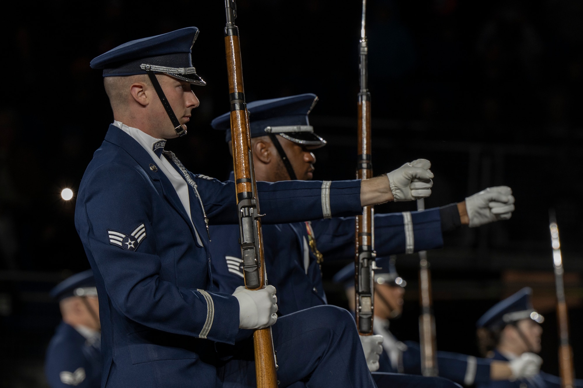 U.S. Air Force Senior Airman Crìsdean James Langan, left, ceremonial guardsman with the U.S. Air Force Honor Guard Drill Team, performs with members of the Drill Team during a performance of the 75th Royal Edinburgh Military Tattoo in Edinburgh, Scotland, Aug. 1, 2025. Langan watched the performance of the Drill team at the Royal Edinburgh Military Tattoo in 2022, which inspired him to enlist in the Air Force. (U.S. Air Force photo by Hayden Hallman)