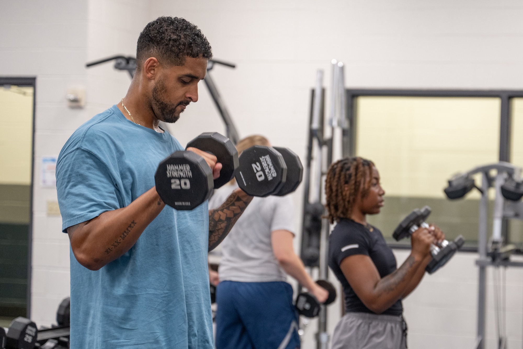 U.S. Air Force Airman 1st Class Ryan Ware, 28th Bomber Generation Squadron weapons load crew member, lifts weights during an advanced Physical Training Leader course led by the Dyess Operational Support Team at Dyess Air Force Base, Texas, Aug. 13, 2025. The Dyess OST provided PTLs hands-on instruction in basic exercise movements to improve unit physical fitness programs. (U.S. Air Force Photo by Airman 1st Class Caleb Schellenberg)