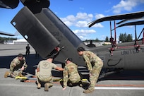 U.S. Army National Guard Soldiers from 1st Battalion 168th General Support Aviation Regiment assist in UH-60 Black Hawk helicopter load up in support of Enduring Partners at Joint Base Lewis-McChord, Wash., August 13, 2025.