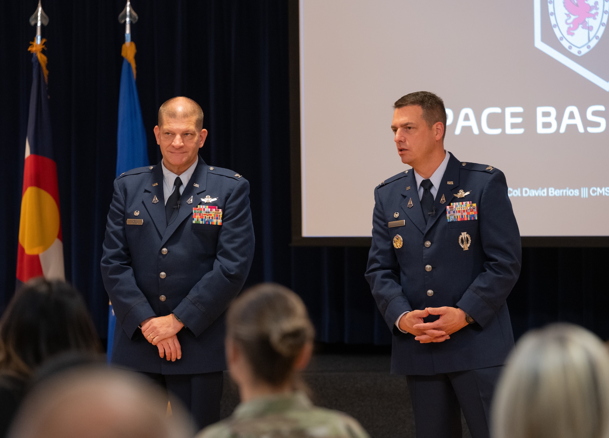 Both Col. Klock and Col. Bogue stand in front of their guest at the end of the State of the Bases event.