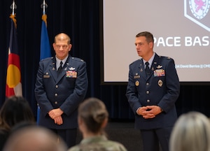 Both Col. Klock and Col. Bogue stand in front of their guest at the end of the State of the Bases event.