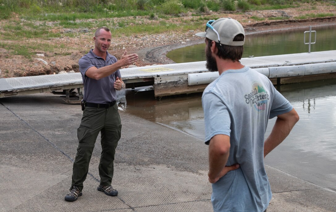 Scott Sterling, a natural resources specialist and park ranger with the U.S. Army Corps of Engineers, Omaha District’s Garisson Project in North Dakota, greets Kyle Parker at the Lake Sakakawea boar ramp, July 17, 2025.