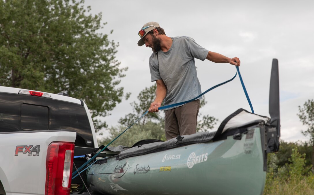 Kyle Parker, canoe enthusiast, straps his custom cruiser-style canoe into the back of a truck for a portage around the Omaha District’s Garrison Dam in North Dakota, July 17, 2025.