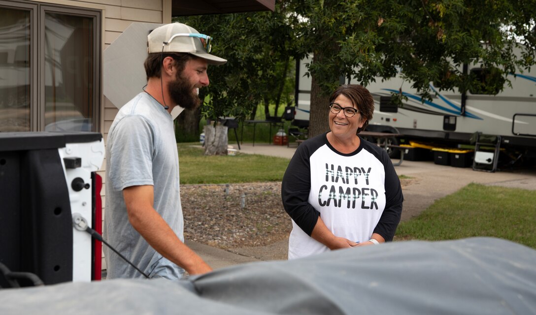 Kyle Parker, a canoe enthusiast paddling across the United States, meets with Laura Vetter, a volunteer camp host, at the U.S. Army Corps of Engineers’ Downstream Campground south of the Garrison Dam in North Dakota, July 17, 2025.